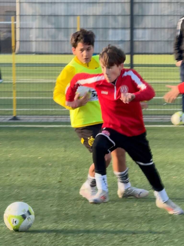 Spieler von Rot-Weiss Essen behauptet den Ball mit perfekter Ballkontrolle gegen einen Verteidiger im Elite Duo-Training der Edin Husic Fußballschule.
